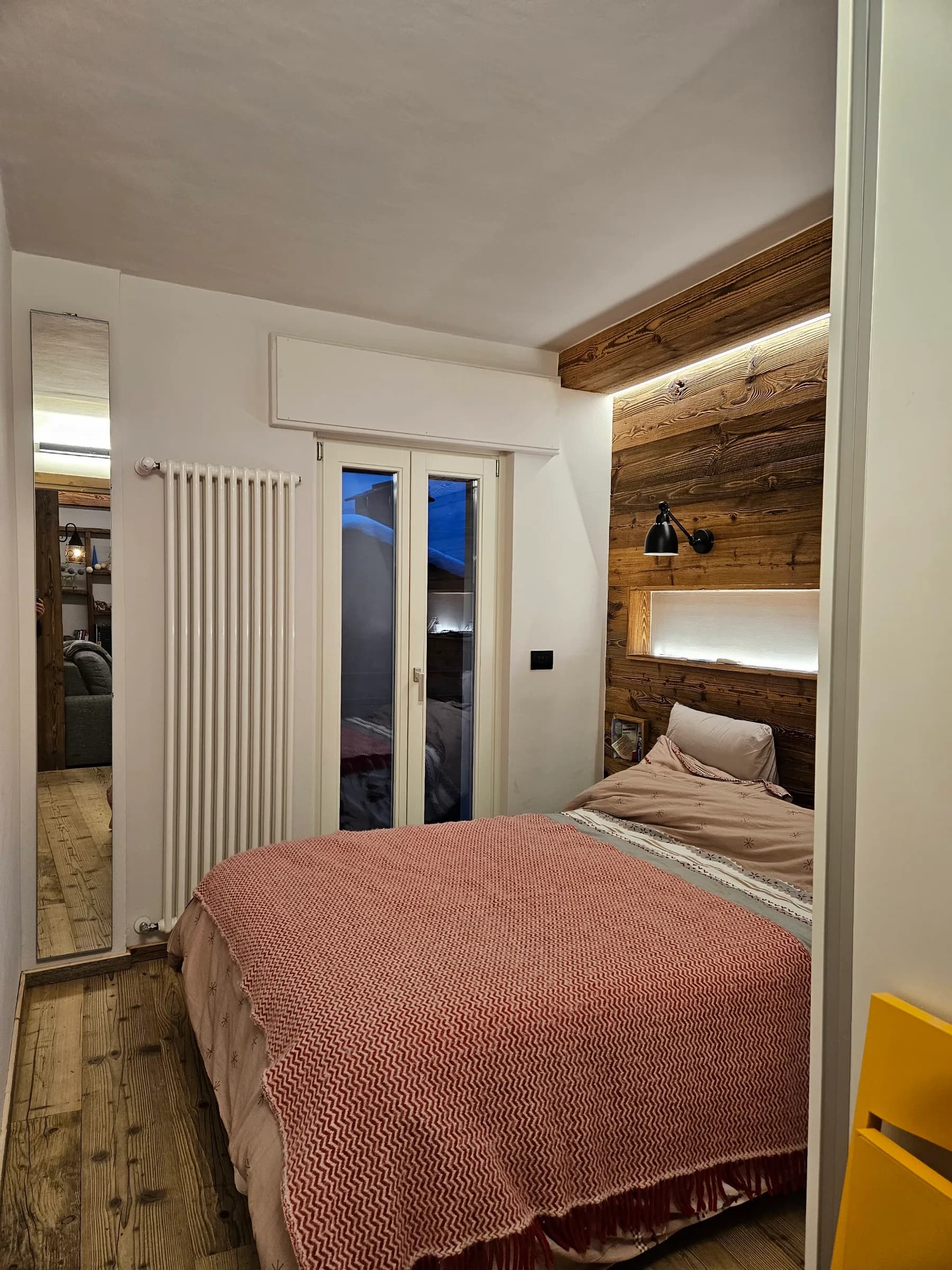 Master bedroom with made bed and warm lighting at Bijou Limone